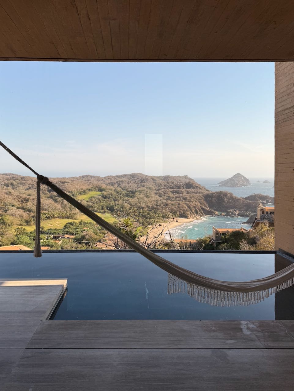 A hammock over a cliffside infinity pool, the Pacific beyond — Four Seasons Tamarindo