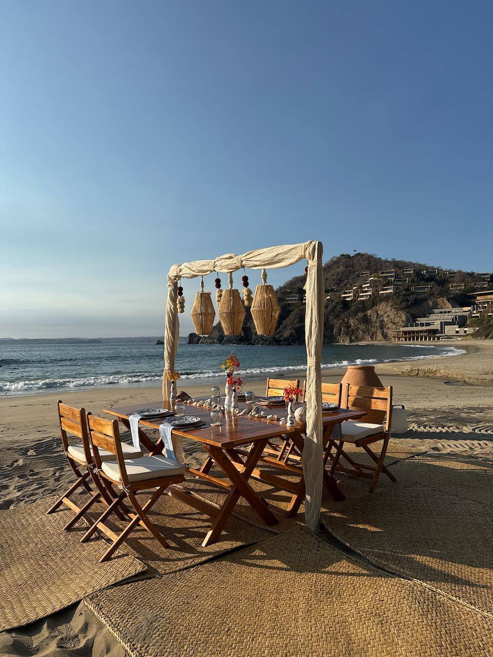 A table set on the sand at dusk