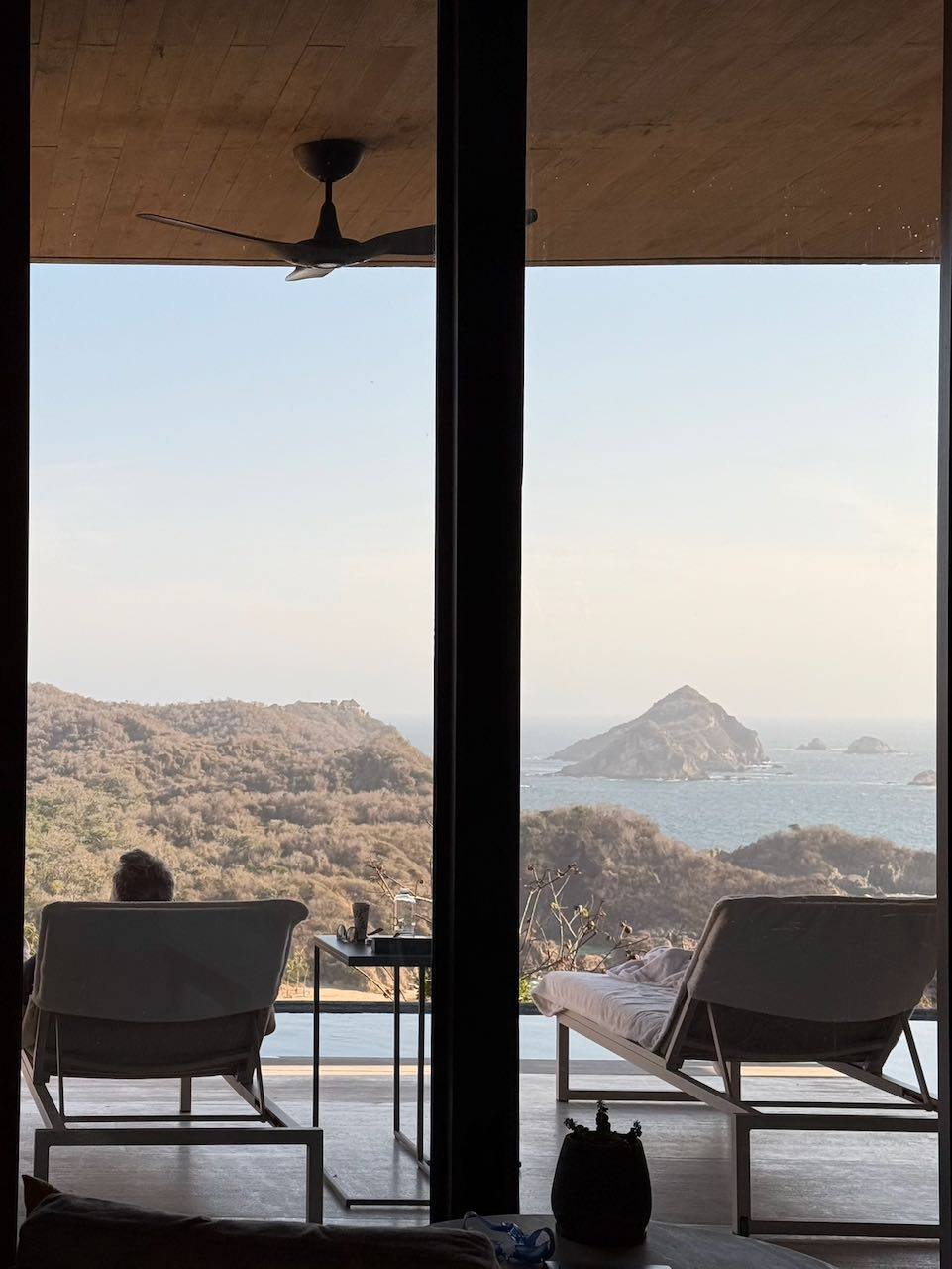 Inside the cliffside suite — glass to the horizon